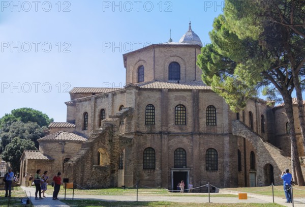 Tourists admire a prime example of early Christian architecture, the octagonal Basilica of San Vitale, Ravenna, Italy, Europe