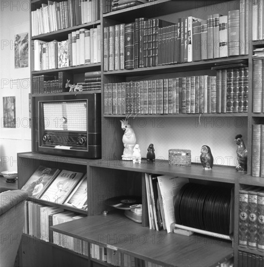 In the 1950s. Interior of a room and a wall with a bookshelf. Besides books it has room for a radio and a gramophone with records. 1956. Svahn ref SVA1