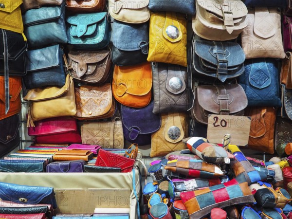 Handmade colourful leather bags and purses on display at traditional souk - street market in Morocco