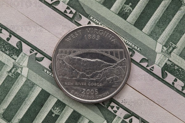 A quarter of West Virginia on US dollar bills. Symmetric composition of US dollar bills and a quarter of West Virginia