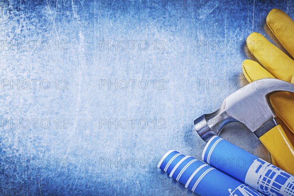 Protective working gloves blue rolled construction drawings claw hammer