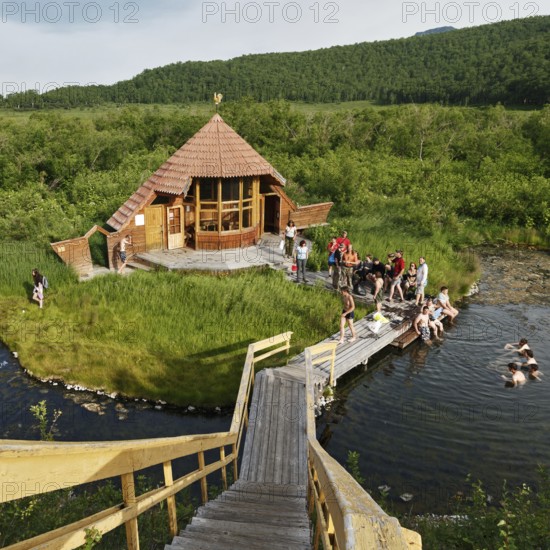 NALYCHEVO, KAMCHATKA PENINSULA, RUSSIAN FAR EAST, JULY 11, 2014: Goryacherechensky group hot springs in nature park Nalychevo, popular travel destinations, tourists swimming in natural thermal pool