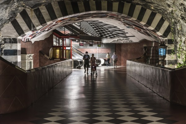 Stockholm, Sweden, 07 24 2019- Decorated interior of the underground metro with a young couple walking through the isle, Europe