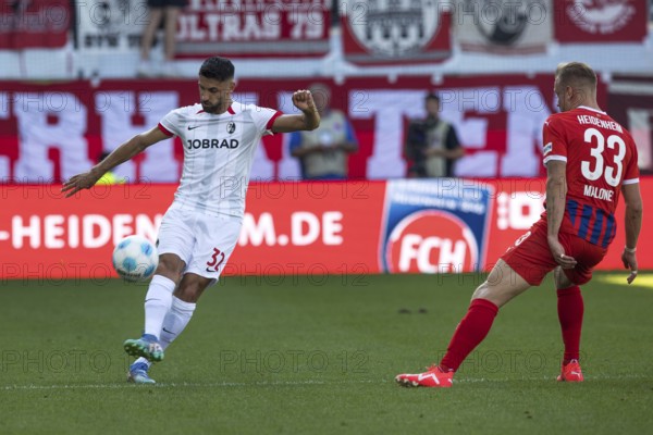 Football match, Vincenzo GRIFO SC Freiburg left with a pass into the deep, Lennard MALONEY 1.FC Heidenheim can only watch, football stadium Voith-Arena, Heidenheim