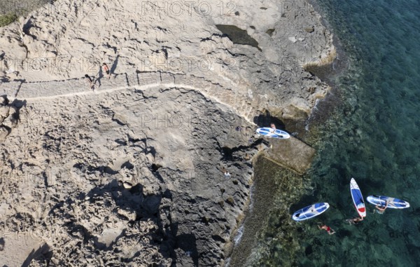 Done view of unrecognized people kayaking in the sea. People active, healthy lifestyle. Cape Grego Cyprus