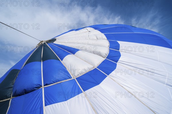 Blue Balloon in the blue cloudy sky
