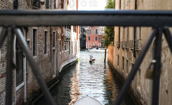 Man on a boat in Venice. Pass thru the channel