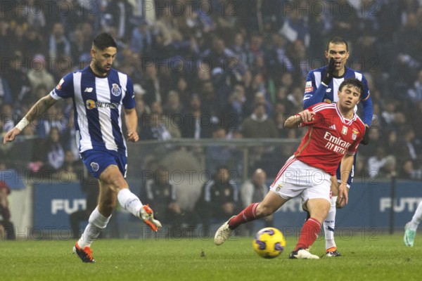 Football match, VARELA FC Porto left with a pass to the right, Joao NEVES Benfica Lisbon right tries to stop him, PEPE FC Porto with his hand protecting his mouth shouts to his team-mates, Estadio do Dragao football stadium, Porto, Portugal, Europe