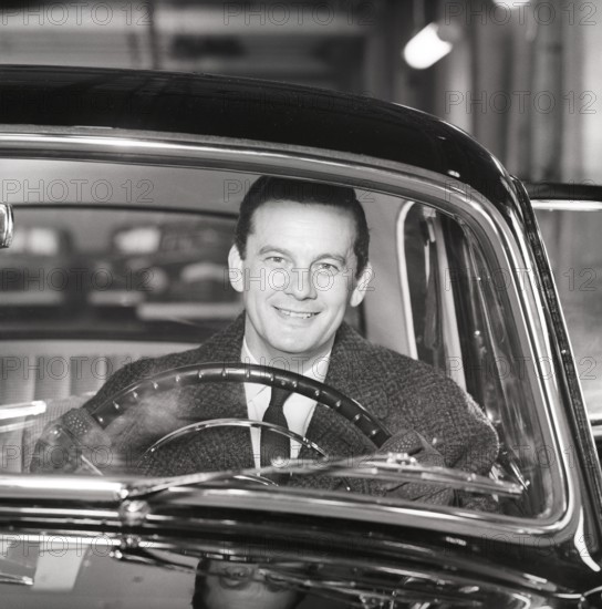 Driving in the 1960s. A man behind the steering wheel in his car looks happy. Sweden 1960. Kristoffersson ref CS93-10