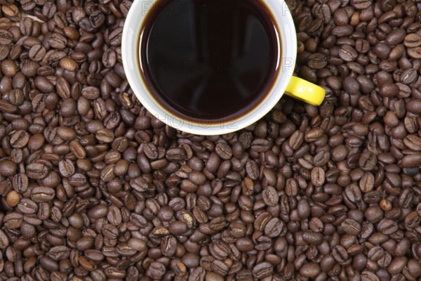 Cup of coffee and coffee beans on a table