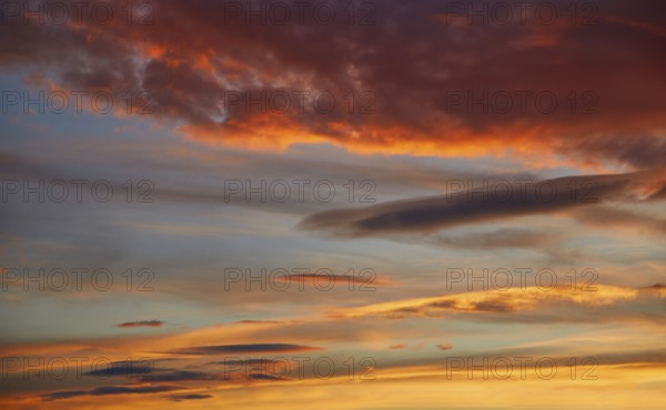 Sunset sky orange clouds over blue background