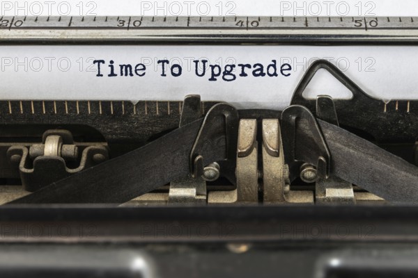 A vintage typewriter with the text time to upgrade
