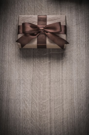 Wrapped vintage giftbox with brown ribbon celebration concept