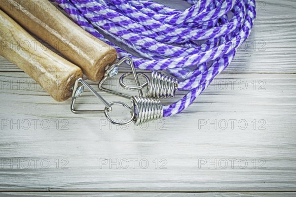 Rolled jump rope on wooden board sports training concept