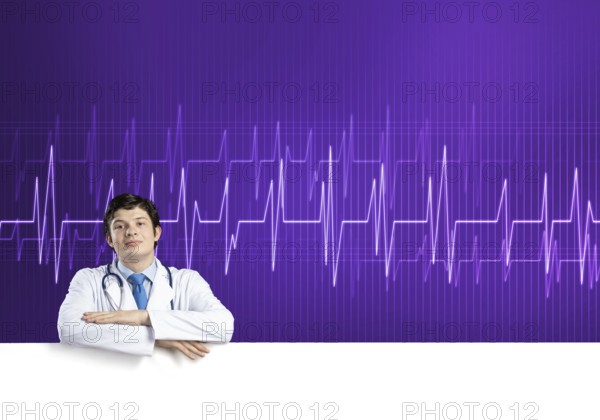 Young handsome doctor holding white blank banner. Place your text