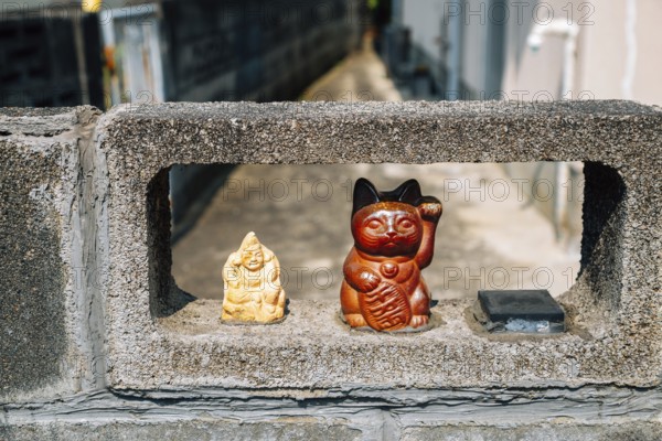Japanese lucky cat maneki neko at Japanese old village Uchiko town in Ehime, Shikoku, Japan, Asia