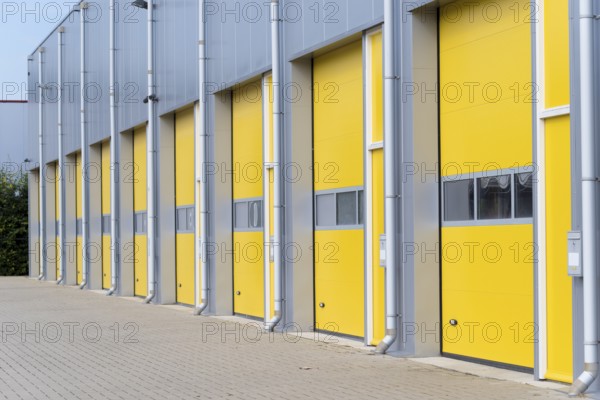 Exterior of a commercial warehouse with yellow roller doors