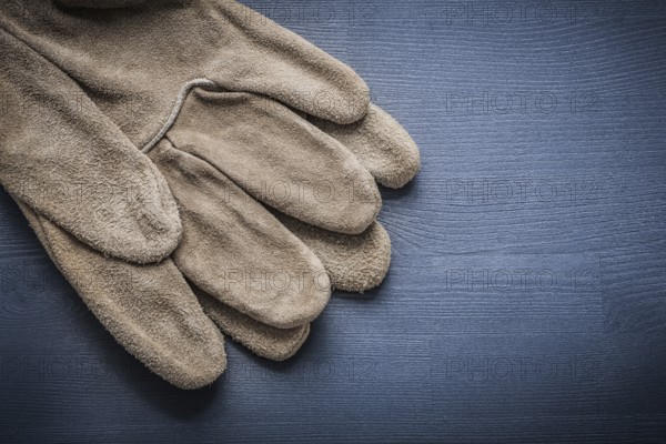 Working gloves on dark blue board