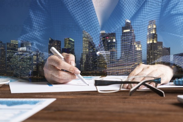 Investment manager analyze financial diagram at wooden desk. Close up woman hand with pen. Strategy planning and banking. Analyst working at workplace in office. Business accounting and management