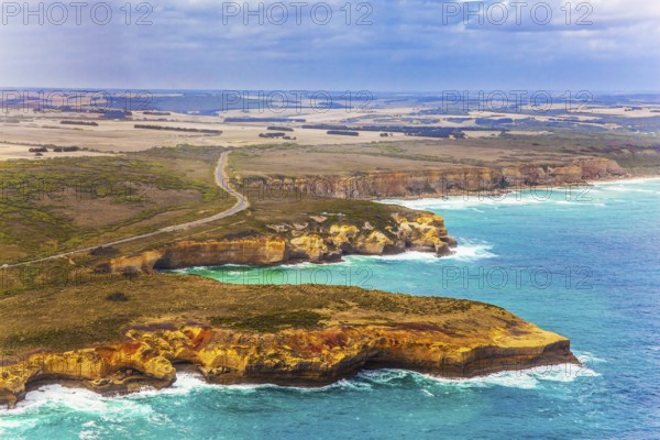 Scenic coastline. Picture taken from a helicopter. Great Ocean Road and the Twelve Apostles is a group of limestone cliffs. Port Campbell Park, Australia. The concept of extreme, active and photo tourism