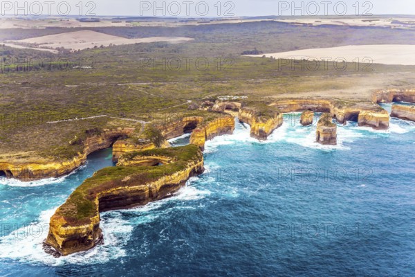 Scenic coastline. Picture taken from a helicopter. Australia, Port Campbell Park. Great Ocean Road and the Twelve Apostles is a group of limestone cliffs. The concept of extreme, active and photo tourism