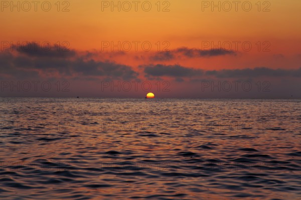 Mediterranean sea sunrise sunset with sun in red sky