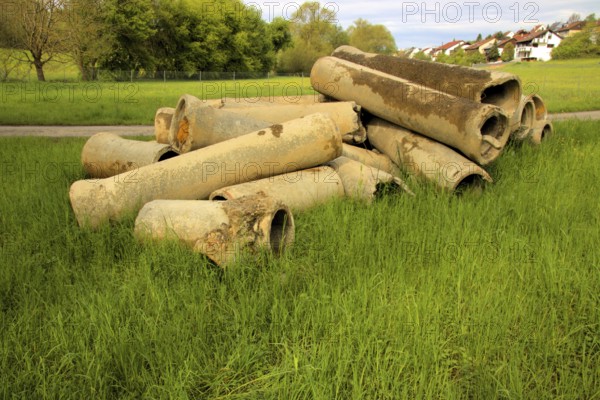 Dismantled concrete pipes in a meadow
