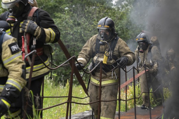 PETROPAVLOVSK-KAMCHATSKY CITY, KAMCHATKA PENINSULA, RUSSIA, AUG 7, 2019: Fire brigade of Fire Department ? 1 of Federal Fire Service in Kamchatka during fire extinguishing, training to overcome fire zone of psychological training for firefighters