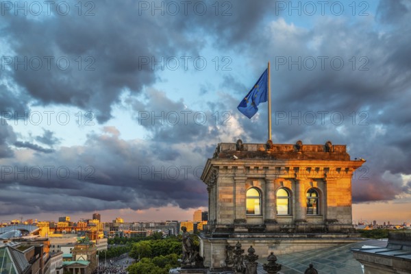 The Berlin Reichstag with evening sky with the flag of Europe and clouds in the background. The Berlin Reichstag with evening sky with the flag of Europe
