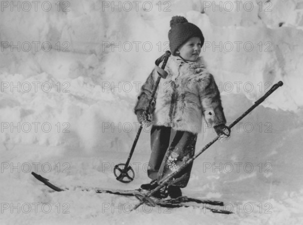 King Harald of Norway. Pictured when being crown prince and a young boy on skis on a winter day. 1940