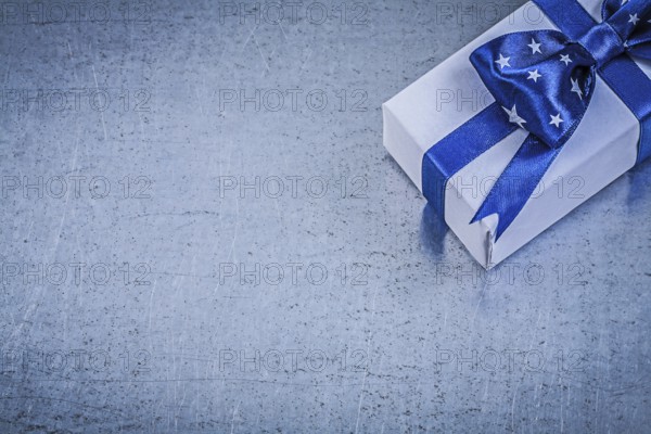 Packed box-container with bow on metallic background celebrations concept