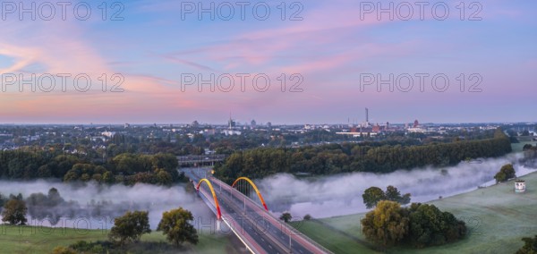 Sunrise and the first rays of sunshine over the fog-covered Ruhr meadows in Duisburg, Germany, Europe