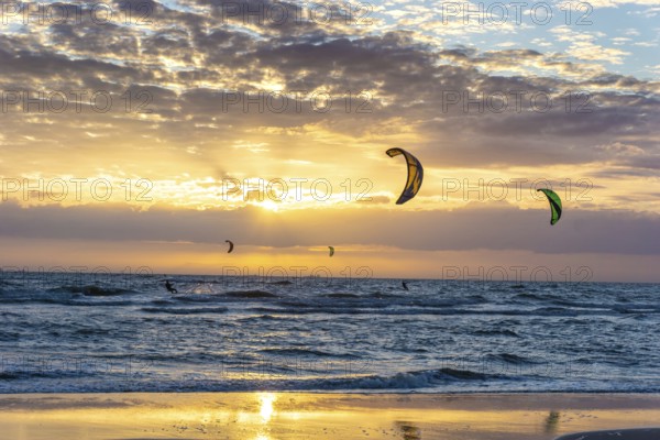 Kite surfing on the sea in the sunset