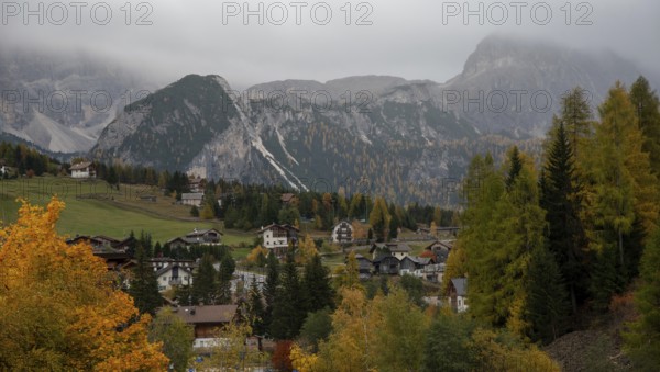 Traditional wooden cottage mountain houses in the green field in the dolomites. Housing in costadedoi Italian apls. Alpine region