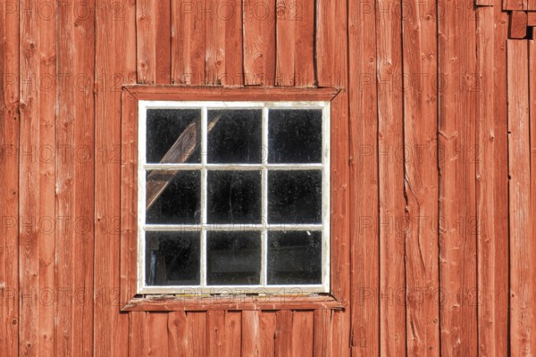 Window on a red weathered barn