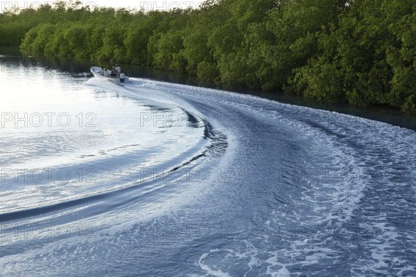 Boat ship wake prop wash curve on sunset lake river