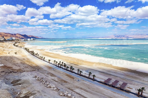 Israel. The Dead Sea is an endorheic salt lake. Magnificent resort for treatment and relaxation. Drone filming. The picturesque embankment is lined with palm trees