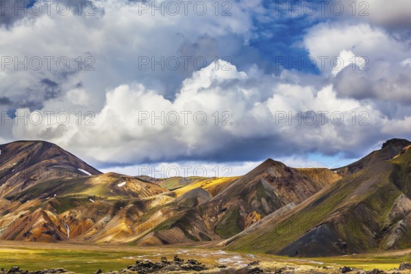 Travel to Iceland in the summer. National Park Landmannalaugar. Multicolored rhyolite mountains of the July sun lit