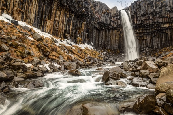 Svartifoss is one of the unique waterfalls in South-Iceland. It is situated in Skaftafell, which belongs to Vatnajokull National park. great black basalt wall behind the falls