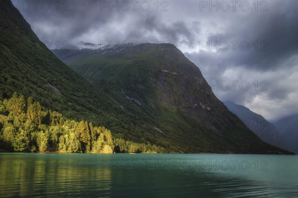The Kjenndalsbreen is part of the Jostedalsbreen, one of the largest glaciers in Norway, and forms an impressive mountain landscape with a beautiful lake in Sande. The glacier Kjenndalsbreen with a lake in Norway is a beautiful place to travel to in summertime