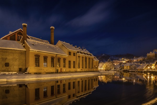 Winter view of Cesky Krumlov, picturesque houses under the castle with snow-covered roofs. Narrow streets and the Vltava river. Travel and Holiday in Europe. Christmas time. UNESCO World Heritage. Czech Republic