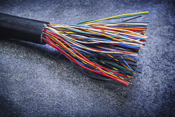 Multicolored electric wires on black background electricity concept
