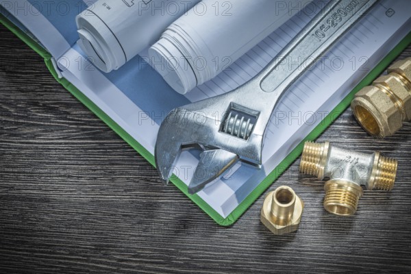Adjustable spanner plumbing pipe connectors rolled construction plans notebook