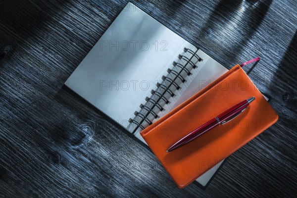 New pocketbooks pen on vintage wooden board