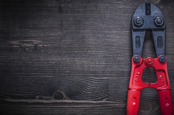 Metal steel cutter on wooden board copyspace construction concept