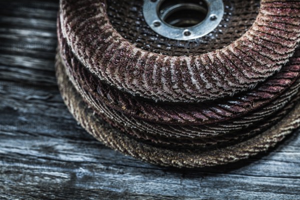 Pile of rotary abrasive discs on wooden board