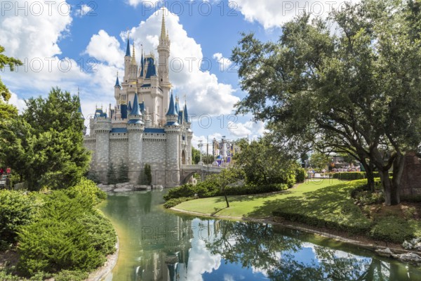 Orlando, Florida – Sept 4: The famous Disney Magic Kingdom Castle and its mirror reflection on the calm waters surrounding the castle in Orlando, Florida, on September 4, 2014, Orlando, USA, North America