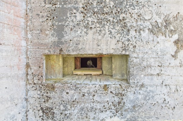 Closeup of an old machine gun opening in a old concrete WW2 bunker with machine gun, Hostikka, Lappeenranta, Finland, Europe
