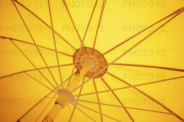An image of a yellow sunscreen umbrella inside