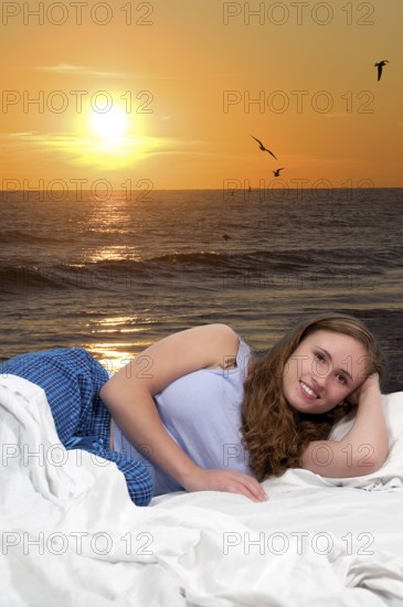 Beautiful young woman in bed at bedtime